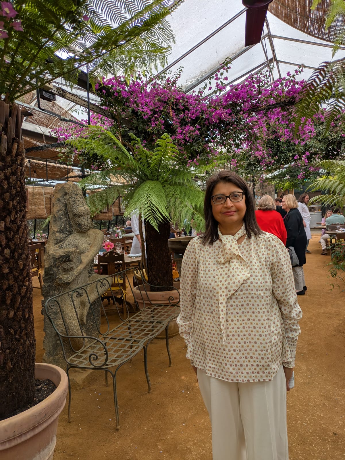 Bagya holding a tray of tea and snacks